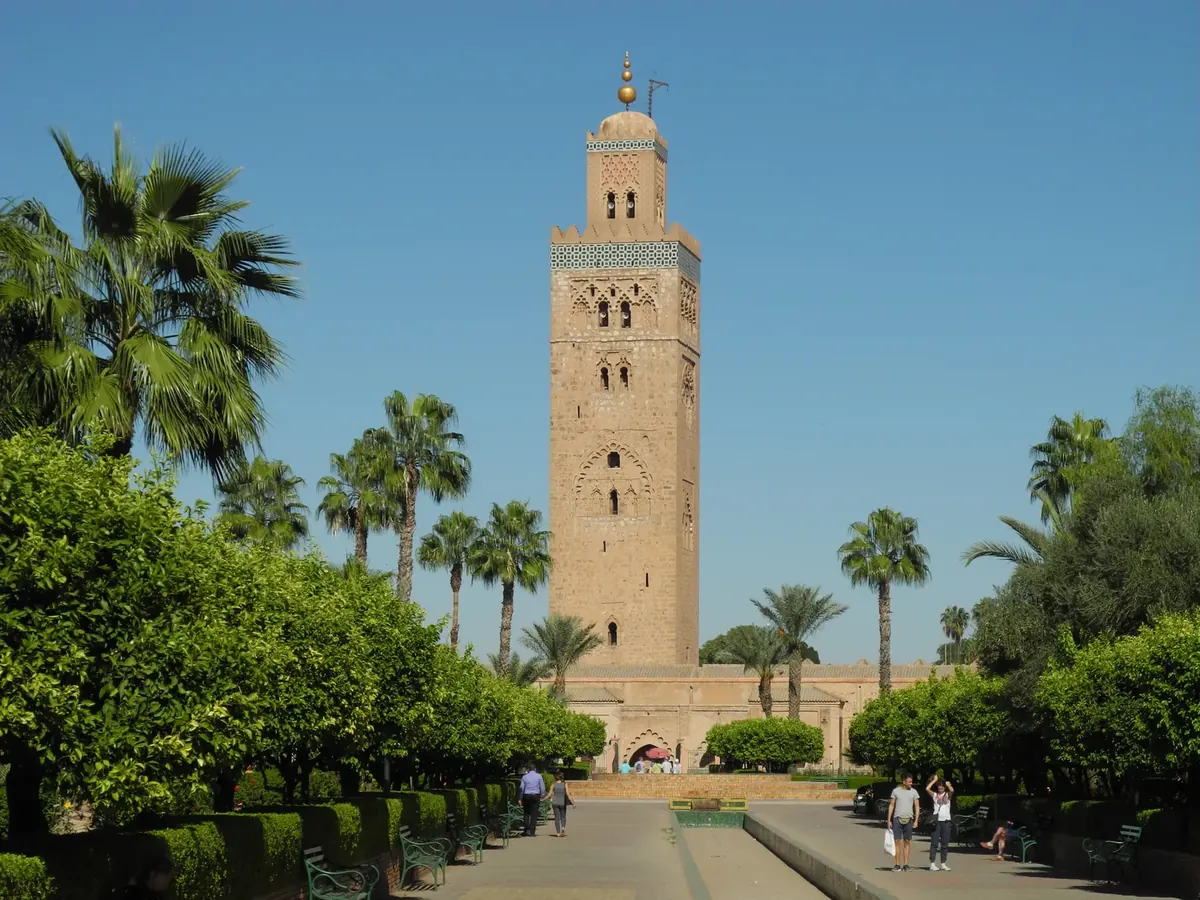 The minaret of the Koutoubia Mosque framed by palm trees